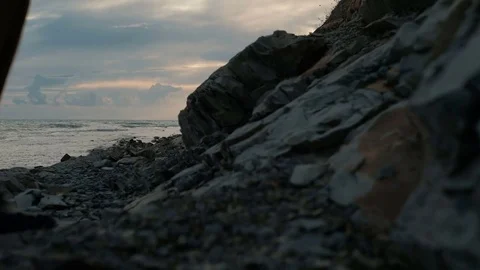 Young man walks along beach in late summer evening outdoors. Stock Footage 80167089