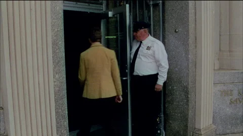 A young man walks into a bank in on old town, Monticello, NY 1989. Stock Footage 272284552