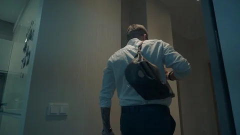Young man walks down the hall Stock Footage 107211584
