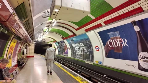 Young man walks down the platform at Piccadilly Circus Underground Station Stock Footage 314398524