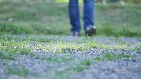 Young man walks down the street. Close-up of legs in jeans and boots Stock Footage 77032914