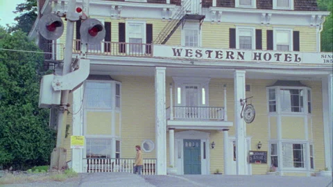 A young man walks down the street in on old town, Monticello, NY 1989. Stock Footage 272248875