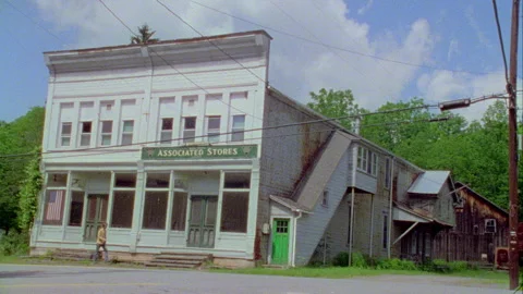 A young man walks down the street in on old town, Monticello, NY 1989. Stock Footage 272250388