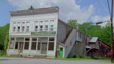 A young man walks down the street in on old town, Monticello, NY 1989. Stock Footage 272251591