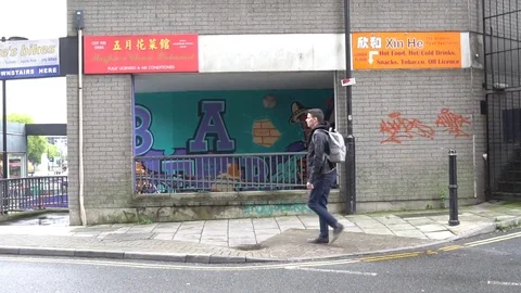 Young Man Walks down urban street of city Видео 84801117