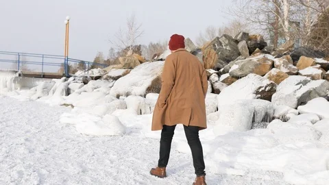 A young man walks on the ice in winter Stock Footage 101317279
