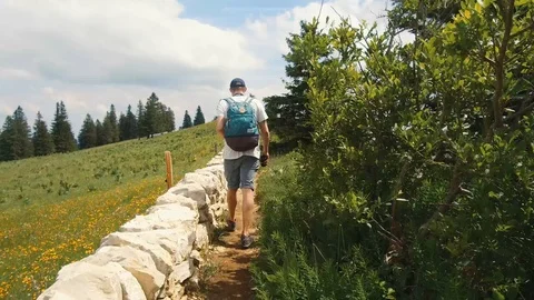 Young man walks on a narrow path 動画素材 91831991
