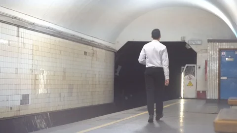 Young man walks on the platform in the subway. man waiting for subway train Stock-Footage 113993657
