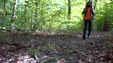 Young Man Walks Through Forest Low Angle 59.97 fps Stock Footage 142018855