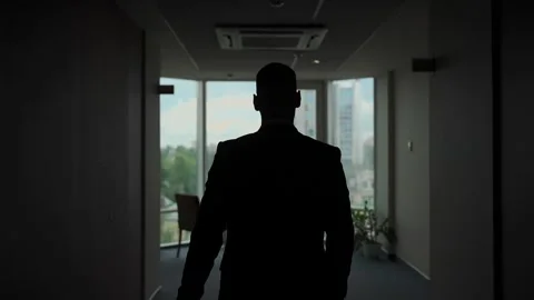 A young man walks towards a window, slow motion video Stock Footage 328299564