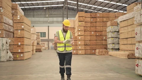 Young man warehouse worker checking stock of wooden pallets Stock Footage 253889448