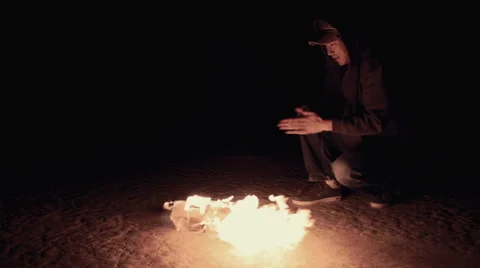 Young Man Warming By Fire Video stock 47923298
