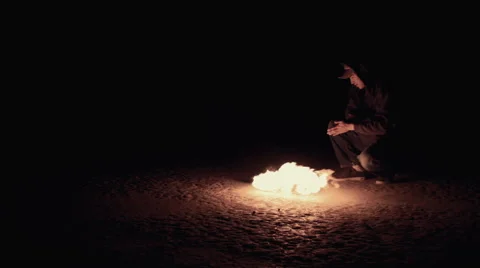 Young Man Warming By Fire (Wide) Stock Footage 47923291