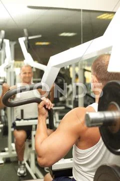 Young man warming up with a simulator Stock Photos