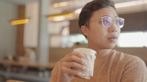 A young man was drinking coffee in a shop. Stock Footage 251974211