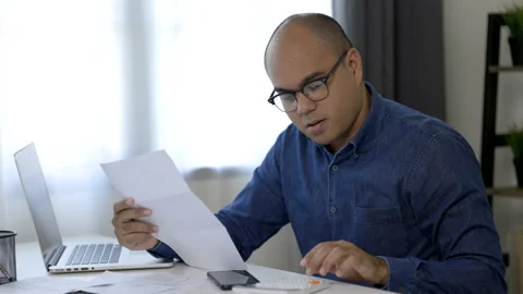 The young man was looking at the bill to calculate his income and expenses. Stock Footage 153204852