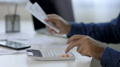 The young man was looking at the bill to calculate his income and expenses. Video stock 153205717