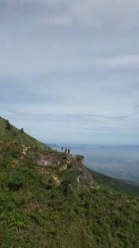 Young man was standing on a rock at the top of the mountain Stock Photos