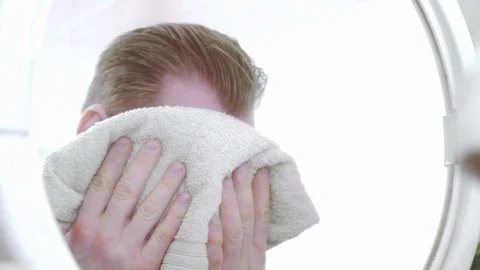 Young man washes face and notice rash Vídeos de archivo 108517687