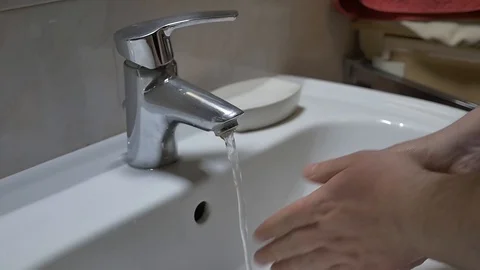 Young man washes hands by soap Stock Footage 127579627
