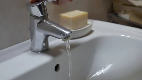 Young man washes hands by soap Stock Footage 127579889