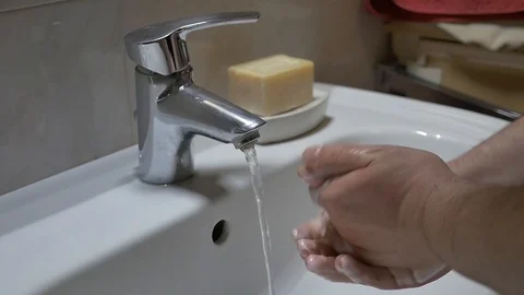 Young man washes hands by soap Stock Footage 127581404