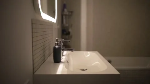 Young man washes his hands in the bathroom 스톡 동영상 60406668
