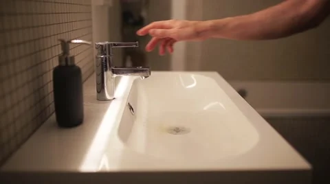 Young man washes his hands in the bathroom Stock-Footage 60406684