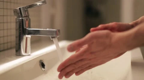 Young man washes his hands in the bathroom 스톡 동영상 60406703
