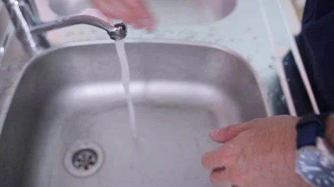 Young man washes his hands thoroughly, male hands in a metal sink Stock Footage 123162178