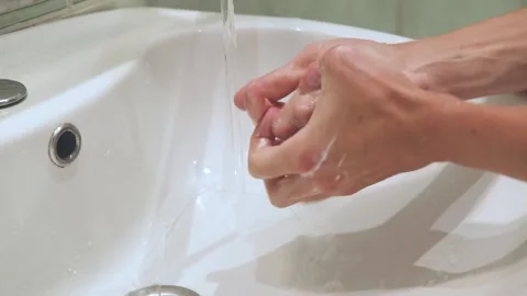 A young man washes his hands in the sink. Stock Footage 219492790