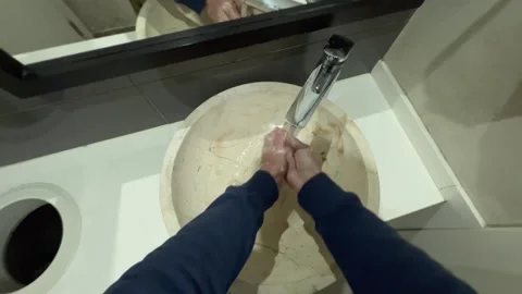 A young man washes his hands with soap and wipes them off with a paper napkin Stock Footage 240659567