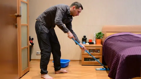 A young man washes a MOP floors Stock Footage 90193644