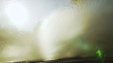 Young man washes windshield view from car interior Vídeos de archivo 88660056