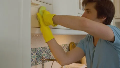 Young man washing kitchen Stock Footage 131067469