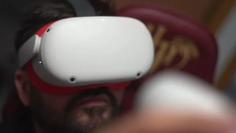 Young man watch virtual reality with VR glasses play games at home 库存影片 252081414