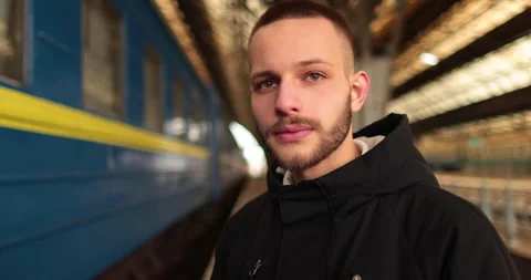 A young man watches a train leave the station. Stock Footage 247354337