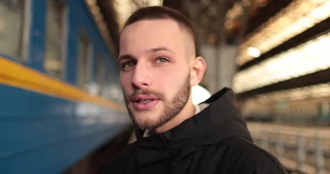 A young man watches a train leave the station. Stock Footage 247354756