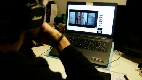 A young man watches a video on a notebook screen Stock Footage 102232243