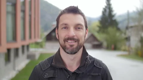 Young man watching and smiling in camera Stock-Footage 49754119
