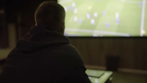 Young man watching football close-up Stock Footage