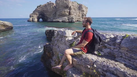 Young man watching the ocean. Stock Footage 212494290