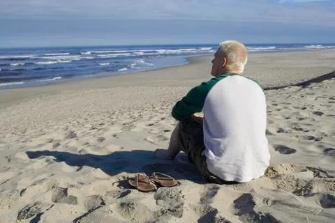 Young man watching the ocean Stock Photos