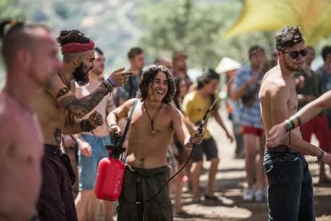 Young man with a water diffuser refreshes the audience on the main stage of the Stock Photos