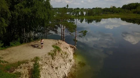 Young man water jump lake drone aerial top view Stock Footage