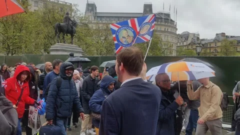 YOUNG MAN WAVES BRITISH FLAG IN LONDON FOR KING CHARLES CORONATION 6 MAY 2023 4K Stock Footage 240493588