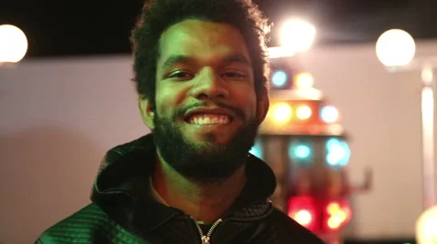 Young man waving and winking to the camera Stock Footage 59556203