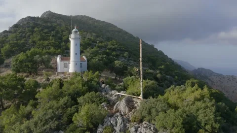 A young man waving in the background of lighthouse. Natural landscape. Stock Footage 133081315