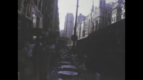 Young man waving in busy madrid street in 1977 Stock Footage 314054119