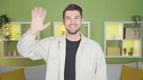 Young man waving at camera and happy. Stock Footage 232216891